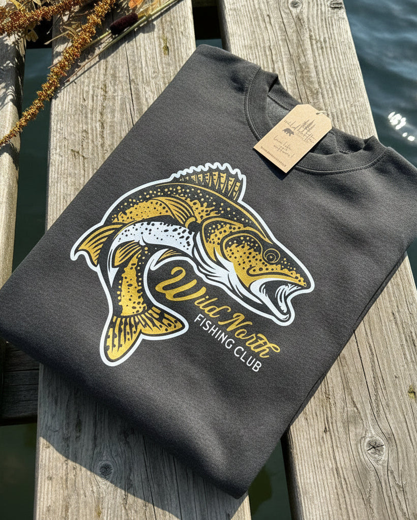 A gray unisex crewneck t-shirt with a graphic print of a fish and the text 'Wild North Fishing Club' on the front.
