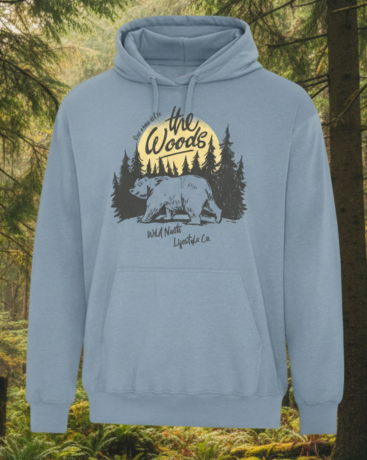 Blue hoodie with bear and forest graphic and 'the Woods' text on a white background